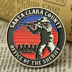 the santa clara county police badge sits on top of an open book next to some books