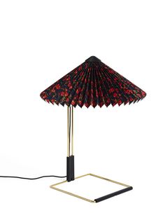 a black and red table lamp with a gold base on an isolated white background,