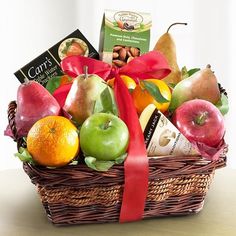 a basket filled with lots of different types of fruits and chocolates on top of a table