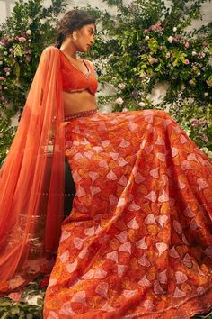 Orange attached cancan lehenga with resham, thread embroidery in floral pattern. Paired with bead embellished padded blouse and tassel dupatta.
Components: 3
Pattern: Embroidery, Embellished
Type Of Work: Resham, thread, floral, bead
Neckline: Notched
Sleeve Type: Sleeveless
Fabric: Tulle, Silk Organza, Raw Silk
Color: Orange
Other Details: 
Lehenga Length: 45 inches
Inverted rounded hem
Criss cross back
Back tassel tie-up
Tassel bordered sheer dupatta
Occasion: Wedding - Aza Fashions Diwali Reception Lace Lehenga, Lace Saree Set With Pallu For Reception, Designer Lace Lehenga For Diwali, Lace Sets With Pallu For Reception, Lace Reception Set With Pallu, Festive Floor-length Lace Choli, Lace Sets For Reception During Diwali, Lace Lehenga With Pallu For Reception, Reception Lace Lehenga With Pallu