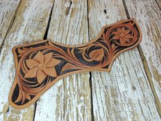 an intricately carved wooden object on a wood floor with white boards and planks