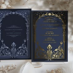 an elegant wedding card with gold and navy blue foil on the front, featuring ornate designs