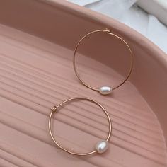 Hand-forged hoops featuring a single freshwater pearl are the perfect everyday accessory. Simple, clean, classic lines you'll never want to take off. Hand-made in our studio. These super lightweight hoop earrings are made of sterling silver or 14kt gold fill wire. Approximately 1 1/4 inch diameter. Everyday Metal Hoop Earrings With Pearl Drop, Minimalist Hoop Pearl Earrings With Ear Wire, Small Pearl Hoop Earrings For Everyday, Minimalist Pearl Charm Hoop Earrings For Everyday, Minimalist Hoop Pearl Charm Jewelry, Minimalist Hoop Jewelry With Pearl Charm, Minimalist Metal Pearl Drop Earrings, Minimalist Everyday Hoop Earrings With Pearl Charm, Everyday Pearl Hoop Earrings