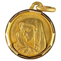 An 18 karat (18K) yellow gold charm pendant designed as a round medal with faceted frame depicting the Virgin Mary. Stamped with the eagle’s head for French manufacture and 18 karat gold, and an unknown maker’s mark. Dimensions: 2 x 1.7 x 0.1 cm (not including jump ring) Weight: 1.51 grams (Chain not included) Maker’s Mark, The Virgin Mary, The Eagle, Gold Medal, Pendant Design, Nails Acrylic, Gold Charm, Virgin Mary, Jump Rings