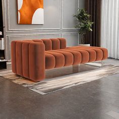 an orange couch sitting on top of a wooden floor