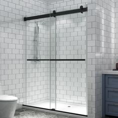 a white tiled bathroom with a walk in shower