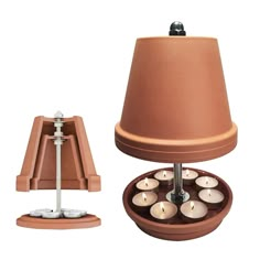 a table lamp that is next to a container with candles in it on a white background