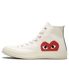 The Comme des Garçons x Chuck Taylor All Star Hi is a must-have sneaker for fashion-savvy individuals. The Off-White canvas upper and red CDG heart logo on the side panels are both stylish and eye-catching, while the vulcanized rubber midsole provides comfort and support. Released in June 2017, this sneaker is also available in a black colorway. (SNKR/Unisex/High Top/Crossover/Kawakubo Rei) Casual Sneakers With Logo-print Tongue And White Sole, White High-top Sneakers With Logo-print Tongue, Casual High-top Sneakers With Logo-print Tongue, Casual Sneakers With Embroidered Logo, Casual High-top Sneakers With Logo-print Tongue And White Sole, Canvas High-top Sneakers With Logo Print, Red High-top Sneakers With Logo-print Tongue, High-top Canvas Sneakers With Logo, Converse Sneakers With Embroidered Logo For Streetwear