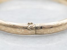 The details on this vintage 14-karat gold bangle are simply stunning! Intricate scrolling botanical designs are engraved in warm yellow gold, covering the entire bracelet. Beautiful on its own or layered with other bracelets this piece is perfect for day or evening wear.Metal: 14K Yellow GoldWidth: 6.3 mmInside Circumference: 6 1/2 InchesMarks: "JW 14K" Stamped on the inside band Formal Bangle Bracelet With Engraving Option, Elegant Gold Bangle With Engraving Option, Classic Etched Bangle For Wedding, Heirloom Etched Bangle For Formal Occasions, Heirloom Etched Bangle For Ceremonial Occasion, Anniversary Etched Gold Bangle Bracelet, Heirloom Etched Bangle, Ceremonial Heirloom Etched Bangle, Etched Gold Bracelet For Weddings