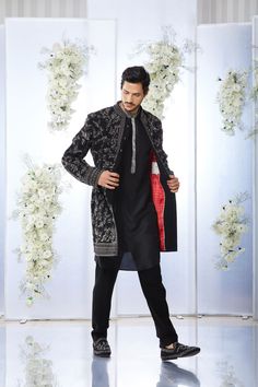 This black short sherwani set features tonal all over zardosi embroidery on a japanese base. It is paired with a black silk kurta and a japanese trouser. Complimenting stole and footwear is also available. From Seema Gujral's Tuscan Summer collection. DELIVERY TIMEPlease allow 4 months for your outfit to arrive.FABRIC DETAILSJapaneseProfessional cleaning only. Black Embroidered Bandhgala Kurta, Traditional Black Bandhgala With Chikankari Embroidery, Ceremonial Black Kurta With Naqshi Detailing, Ceremonial Black Kurta With Naqshi, Designer Black Kurta With Naqshi, Designer Black Straight Kurta, Designer Black Embroidered Kurta, Designer Embroidered Black Kurta, Black Nehru Jacket With Zari Work