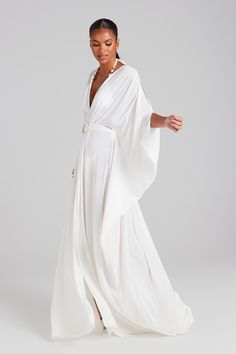 DESCRIPTION & FEATURES SERENA is a lightweight pullover maxi kaftan in off-white, crafted from chiffon with pleat detailing, a self-fabric gold-look pearl buckle belt, and is finished with two slit openings to the front. Pair with our GISELLE White Swimsuit to complete the look. - Sheer off-white chiffon fabric - Low plunge v-neckline - Pleat detailing to the shoulders - Billowing short sleeves - Self-tie belt with belt loops - Circular gold-look pearl buckle belt - Two slits to the front - Loos Nadine Merabi, White Kaftan, Loose Kimono, Maxi Kaftan, Wedding Abroad, White Swimsuit, White Chiffon, Chiffon Maxi, Buckle Belt