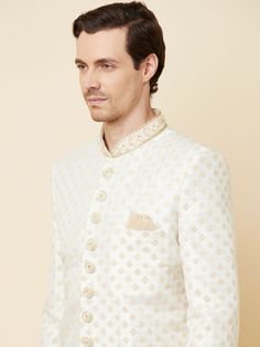 This Royal White Embroidered sherwani will instantly give an elegant look. Made from polyester cotton fabric, this 3 piece sherwani set features a white royal sherwani, front buttons fastening, designer cuff buttons, pocket square, and a mandarin collar. This white base sherwani has beautiful subtle gold Jaal thread-sequin embroidery work all over. It is paired with white churidar pants and matching dupatta. An ideal outfit for traditional & special events.

Size Chart For Men





	
	
					Men' Designer Off-white Bandhgala For Eid, Designer Off White Festive Sets, Designer White Unstitched Kurta, Designer Unstitched White Kurta, White Nehru Jacket For Diwali Reception, White Nehru Jacket For Reception Diwali, Designer Cream Bandhgala For Diwali, Designer White Traditional Wear For Diwali, Formal Off White Unstitched Sherwani