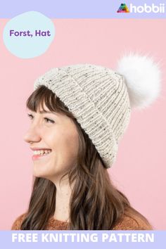 a woman wearing a knitted hat with a white pom - pom