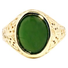 Forged in 14 carat yellow gold, this gorgeous vintage ring, circa 1980s, features an opulent deep green Nephrite jade cabochon set on patterned domed shoulders. This lovely adornment has been named The Logan Ring. She is a graceful everyday ring with wonderfully dark green hues and is fit for any occasion. The Logan Ring Gem Details The oval deep green Nephrite jade cabochon measures approximately 13 x 10 millimetres. Ring Size T 1/2 (Australia and UK sizing) or 10 (US and Canada) The Logan Ring Collectible Green 14k Stamped Jewelry, Classic Green Cabochon Emerald Ring, Classic Green Jade Jewelry, Classic Green Cabochon Ring, Heirloom Style Green Emerald Ring With Polished Finish, Heirloom Style Polished Emerald Ring, Heirloom Jade Jewelry In Green, Heirloom Green Oval Cabochon Jewelry, Heirloom Green Oval Cabochon Rings