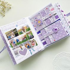 an open scrapbook with pictures and hearts on the pages, sitting on a table