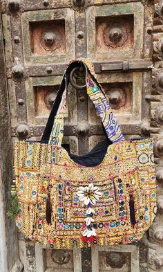 About bag  Indo-gypsy fusion, everyday use hand bag made from Banjara fabrics sourced from Vintage tribal costumes of regions of Rajastan and Gujarat. These are embellished with light catching coins, and intricate bead work tassels. Company details:  Company name: Houseoftextile  Contact number: +919784447473  Email id: houseoftextile77@gmail.com  Shipping & custom : Delivery through one of the finest service providers : Skyway, Fedex, UPS  And DHL. Any local taxes\custom has to be paid by clien Festive Rectangular Shoulder Bag With Mirror Work, Bohemian Embellished Bag For Festive Occasions, Festive Rectangular Bag With Mirror Work, Bohemian Embellished Shoulder Bag For Festive Occasions, Bohemian Multicolor Bags With Zari Work, Bohemian Multicolor Zari Work Bag, Bollywood Bags With Mirror Work For Festivals, Bollywood Style Bags With Mirror Work For Festivals, Bohemian Embellished Bag For Festivals