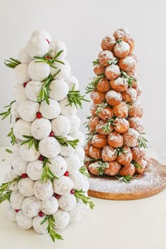 two christmas trees made out of donuts and sprinkled with powdered sugar