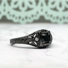 M A T E R I A L S ~ Solid Sterling Silver ~ Black Rhodium S T O N E S Cruelty Free ~ Simulated Black Diamond ~ Center Stone : 0.45ct ~Side White Diamonds: 0.12ct D I M E N S I O N S ~ Band: 3.00mm ~ Setting: 5.75mm Height 9.00mm Width R I N G C A R E ~ Simple instructions to care for the ring is not expose your jewelry to chemicals like bleach, chlorine, hairspray, to avoid chemical reactions or breakdown of materials. (Just as you would with any jewelry) ~ Try not wear your jewelry in the showe Black Rhodium Ring, Black Diamond Engagement Ring, Engagement Ring Art Deco, Black Diamond Engagement, Sapphire Band, 3 Stone Rings, Black Diamond Ring Engagement, Black Ring, Chemical Reactions