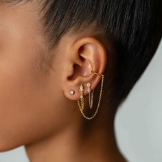 A unique ear cuff that features a chain and connected stud earring.| Lead and Nickel free. Sold as a SINGLE earring, purchase 2 for a pair Gold Vermeil (Thick layer of Gold plated over Sterling Silver) Cubic Zirconia Gemstone Crystal Size 3mm(0.12in), Chain Length 70mm(2.75in) Inner diameter 9mm(0.35in), Band Thickness 1.5mm(0.06in) Adjustable sizing #E515-Gx1 Earrings That Connect, Ear Piercings Chains Cuff Earrings, Luxury Gold Earrings With Delicate Chain, Chain Earings Piercings, Chain Ear Piercings, Ear Inspo Jewelry, Chain Earrings Aesthetic, Ear Piercings Chain, Unique Ear Cuffs