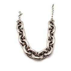 "Make every outfit a stunner with this vintage jumbo Kenneth Jay Lane cable chain silver plated necklace. The necklace adjusts from 16\" - 18\" and fits snugly around your throat. A wonderful designer necklace to add to your collection! Kenneth Jay Lane began his work in 1963 after he graduated from the Rhode Island School of Design. He studied under Hattie Carnegie and began his work designing shoes for Christian Dior. He skyrocketed into the costume jewelry industry when designing pieces for E Silver Chunky Metal Chain Necklace, Chunky Metal Oval Link Necklace, Silver Chunky Chain Link Necklaces, Chunky Oval Link Metal Chain Necklace, Chunky Metal Chain Necklace With Oval Links, Silver Chunky Link Chain Necklace, Silver Jewelry With Oval Link Chain Strap, Vintage Silver Cable Chain Jewelry, Vintage Silver Jewelry With Cable Chain