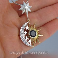 "Please note that the pendant is NOT in stock - it will be made to order. Please allow time for production. SUN and MOON pendant was designed and crafted by the artist and jewelry designer Sergey Zhiboedov (my husband). For ages, the crescent Moon and the Sun, seen by the ancients as the God and the Goddess, has become a symbol of the duality of deity.  The pendant is made in silver and 14k yellow gold and features a natural 7mm Black Spinel for the Sun. The crescent silver Moon is set with nine Silver Celestial Jewelry With Sun And Moon Design, Elegant Silver Jewelry With Sun And Moon Design, Elegant Silver Sun And Moon Design Jewelry, White Gold Sterling Silver Sun And Moon Jewelry, Spiritual Sun And Moon Design Jewelry For Anniversary, Black Moon-shaped Jewelry With Sun And Moon Design, Black Moon-shaped Sun And Moon Jewelry, Black Moon Jewelry With Sun And Moon Design, Silver Pendant Jewelry With Sun And Moon Design