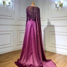 Gorgeous Grape Hue: A rich grape purple color that exudes sophistication and allure, making it an ideal choice for evening events and parties in 2024 . Elegant Silhouette: The dress boasts an elegant silhouette that drapes beautifully, enhancing your natural grace and charm. High Split: A high split in the skirt adds a touch of sensuality and allows for ease of movement, perfect for dancing and making a grand entrance. Luxurious Satin Fabric: The gown is crafted from luxurious satin fabric, addi Purple Floor-length Dress For Banquet, Elegant Purple Gown For Gala, Elegant Purple Evening Gown, Elegant Purple Evening Dress For Gala, Purple Evening Wedding Dress, Elegant Purple Floor-length Evening Dress, Elegant Purple Formal Gown, Purple Long Sleeve Gown With Sweep Train, Purple Evening Dress For Gala