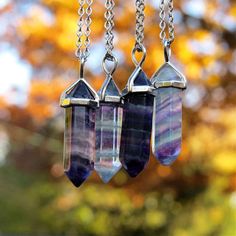 "This listing is for one colorful rainbow Fluorite necklace in your choice of stone. These Fluorite point necklaces have beautiful bands of purple, clear, and green. A silver plated bail tops each  crystal point and suspends from a shiny silver plated, or stainless steel chain with your choice of length from 18\" to 22\" inches or on an adjustable black cord. Wear fluorite jewelry for this stone's energy healing properties or as a natural accessory piece from nature.   Details Stone - Rainbow Fl Fluorite Jewelry, Fluorite Necklace, Natural Accessories, Crystal Point Necklace, Fluorite Stone, Healing Crystal Jewelry, Witchy Things, Green A, Fluorite Crystal