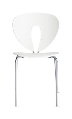 a white chair sitting on top of a metal frame with an oval shaped backrest