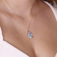 "Pear cabochon shaped beautiful Ethiopian opal pendant necklace. It's featured on 14k yellow solid gold handmade prong setting, diamond bail and 14k yellow solid gold chain. Opal is oval shaped cab cut and unique. DETAILS  Pendant size : 21.5mm height, 14.5mm width Bails has 3 diamonds total 0.01 ct.  It's coming with 16' to 18\" adjustable 14k solid gold chain.  all our raw materials are sourced from US-based companies for the quality and safety of our handmade products.  this necklace is handc Elegant Drop Opal Jewelry, Iridescent Fine Jewelry As A Gift, Fine Jewelry Opal Birthstone, Opal Birthstone Fine Jewelry, Teardrop Opal Jewelry For Anniversary, Teardrop Cabochon Necklace For Anniversary, Fine Opal Jewelry For Gifts, Fine Jewelry Opal Gift, Fine Opal Jewelry As A Gift