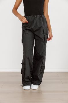 These Urban Glide Parachute Pants provide a comfortable and stylish fit for any urban adventurer. The lightweight, durable fabric allows for maximum movement and breathability, perfect for exploring the city. With a modern design and functional features, these pants are a must-have for any fashion-forward individual. Athleisure Pants With Cargo Pockets, Urban Pants With Functional Pockets For Outdoor Activities, Urban Cargo Pants For Outdoor, Techwear Hiking Pants With Multiple Pockets, Techwear Pants With Multiple Pockets For Hiking, Urban Pants For Outdoor Activities With Side Pockets, Urban Pants With Pockets For Outdoor Activities, Urban Style Bottoms For Outdoor, Urban Style Full-length Bottoms For Outdoor Activities