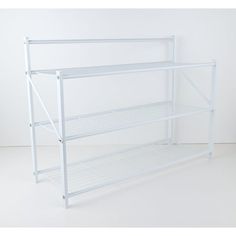 a white shelf with three shelves on each side and one shelf below it, against a white wall