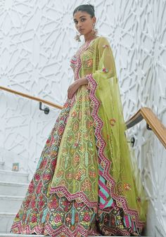 Step into the spotlight with this exquisite Multi Colour Embroidered Bridal Lehenga Set. Perfect for summer weddings or Mehendi ceremonies, this set boasts a captivating multi-coloured organza blouse embellished with intricate resham and patra work. The ensemble is completed with a dazzling multi-coloured organza lehenga and a matching yellow net dupatta. Be the centre of attention and make a statement with this stunning bridal outfit. Composition : Blouse- Organza, Lehenga- Organza and Dupatta- Net Care: Dry Clean Only and Vacuum Storage This product can be customized for sleeves, length of blouse and neckline Delivery : 6-8 weeks as the product is hand crafted. Check Size Guide or choose MySize for free customisation (All Sizes above XL can be made at 15% additional cost) For more inform Floor-length Lehenga With Multicolor Embroidery For Diwali, Multicolor Organza Anarkali Set For Eid, Semi-stitched Multicolor Lehenga With Sheer Dupatta, Multicolor Organza Anarkali Set For Navratri, Navratri Multicolor Organza Anarkali Set, Anarkali Gown With Multicolor Embroidery And Pallu, Multicolor Embroidered Gown With Dupatta For Wedding, Wedding Gown With Multicolor Embroidery And Dupatta, Multicolor Organza Salwar Kameez For Wedding