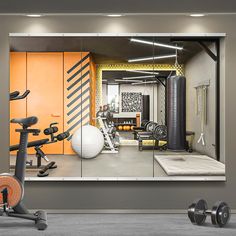 there is a gym with exercise equipment in the room and on the wall behind it