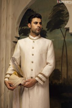 Formal White Raw Silk Traditional Wear, White Raw Silk Sets For Wedding, White Raw Silk Wedding Sets, White Traditional Wear With Naqshi Drape, White Traditional Wear With Naqshi, Groom's White Sherwani With Dabka Work, Designer White Raw Silk Sherwani, White Raw Silk Kurta For Formal Occasions, White Dabka Work Sets For Groom