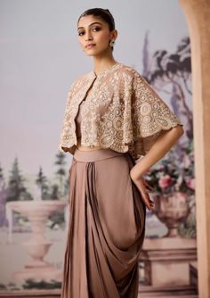 Featuring a luxurious golden satin dhoti skirt paired with a stunning fully hand-embroidered cape. The cape is adorned with exquisite cutdana, sequins, and beadwork, adding an opulent touch to the ensemble. Complemented by a chic bralette blouse, this outfit effortlessly marries modern aesthetics with traditional craftsmanship, making it a captivating choice for special occasions or celebrations. Dhoti Skirt, Embroidered Cape, Indian Kurti, Skirt And Blouse, Satin Color, Modern Aesthetics, Indian Design, Every Woman, Indian Wedding