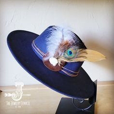 If you’re looking for the perfect accessory to complement your favorite boho style, look no further. This Boho-Style Western Felt Hat w/ Natural Feather & Turquoise Hat Accent by The Jewelry Junkie is absolutely everything that you need. Not only is it easy to incorporate into any and all outfits, but the genuine leather and natural feathers of the band immediately elevate whatever it is you’re wearing. One Size Hat with adjustable inner hat liner (see last photos) The same primary feathers will Blue Bohemian Felt Hat With Short Brim, Bohemian Blue Felt Hat With Short Brim, Bohemian Blue Short Brim Felt Hat, Blue Bohemian Wide Brim Felt Hat, Bohemian Blue Wide Brim Felt Hat, Blue Wide Brim Bohemian Felt Hat, Blue Bohemian Felt Hat For Festival, Blue Bohemian Fedora With Curved Brim, Blue Bohemian Fedora With Short Brim