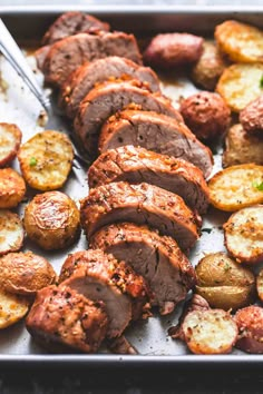 roasting meat and potatoes on a baking sheet