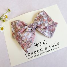 "Liberty of London x HK fabric imported from Japan featuring dusty pink floral print.  Comes in our twirl style bow on a lead free alligator hair clip clip, a soft nylon baby headband or our hard bow headband. Hard knot headband fits toddlers, kids and adults.  Small size bow measures 3.75\" Medium size bow measures 4.50\" Large size bow measures 5.50\" Top knot measures 3.0\" Hard covered headband has a large sized bow.  Handmade with love and magic in Southern California." Whimsical Pink Hair Accessories With Handmade Flowers, Pink Hair Accessories For Babies In Summer, Pink Hair Bow Accessories For Spring, Pink Satin Bow Hair Accessories For Spring, Pink Hair Accessories With Handmade Flowers For Summer, Spring Pink Satin Bow Hair Accessories, Spring Pink Hair Accessories With Satin Bow, Spring Pink Hair Accessories With Bow, Cute Adjustable Bow For Summer