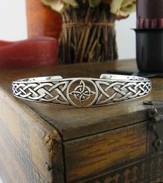 Witch's Knot Open Bangle Cuff Bracelet with Celtic Knots | Woot & Hammy Silver Symbolic Metal Cuff Bracelet, Symbolic Round Adjustable Cuff Bracelet, Adjustable Symbolic Cuff Bangle Bracelet, Adjustable Symbolic Sterling Silver Cuff Bracelet, Adjustable Symbolic Sterling Silver Bangle Bracelet, Viking Costume Ideas, Witch's Knot, Finding Feathers, Celtic Knot Bracelet