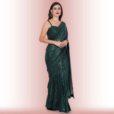 Introducing the exquisite "1 Minute Sequin Saree - Iridium"! ✨ Crafted from luxurious georgette, this saree combines timeless elegance with modern convenience. Designed for the busy fashionista, it comes pre-stitched for hassle-free draping. The dazzling iridium sequins glisten with every step, ensuring you steal the spotlight wherever you go. 💃Complementing this beauty is a classy spaghetti strap blouse that adds a touch of sophistication and allure to your ensemble. ✨Ideal for weddings, parti Glamorous Georgette Pre-draped Saree For Celebration, Green Cutdana Pre-draped Saree For Evening, Elegant Green Pre-draped Saree For Celebration, Formal Floor-length Pre-draped Saree For Diwali, Glamorous Saree With Unstitched Blouse For Celebration, Glamorous Saree With Dupatta For Celebration, Glamorous Festive Saree For Celebration, Glamorous Floor-length Georgette Pre-draped Saree, Glamorous Pre-draped Saree For Celebration