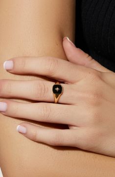 We heard you love bold accents, so we made you this gold signet ring to amp up your seasonal wardrobe. This bold ring is dipped in 14K gold and features an onyx stone beneath a unique star symbol. Wear this gold signet ring with our Amara Mother of Pearl ring for a juxtaposed look. Dipped in 14K gold Features an onyx stone Depth: 3.41mm - 0.13” Weight: 2.24g Crafted In China Onyx Ring Women, Gold And Onyx Ring, Floral Signet Ring, Black And Gold Wedding Ring For Women, Local Eclectic Rings Engagement, Ring Stacks Aesthetic, Gemstone Rings Aesthetic, Gold Alternative Jewelry, Signet Engagement Rings Women