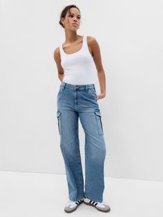 Fit: A full-length loose jean that's fitted on the waist & relaxed all the way down.  Fabric: 99% Organic Cotton, 1% Stretch.  Stretch: Low Stretch Jeans.  Authentic denim with a soft & easy lived-in feel. ​ Rise: Mid Rise Jeans.  Look: A five-pocket jean in a light indigo wash.  Details: Zip fly, five-pocket styling & cargo pockets at sides.  Responsibly Made: This pair of jeans is part of our water-saving Washwell program.  Compared to conventional wash methods, Washwell has saved millions of liters of water since 2016.  Our Mid Rise Jean has a 10" 25 cm) rise. ​ Relaxed through the hip & thigh.  Loose, straight leg. ​ Full-length jean.  Hits below the ankle.  17" 43 cm) leg opening.  Inseam: Petite 27. 5" 70 cm), Short 29" 74 cm), Regular 30" 76 cm), Long 32. 5" 83 cm), Tall 34" 86 cm). Cargo Jeans Outfit, Gap Jeans Women, Womens Jeans Bootcut, Jeans Look, Jeans Cargo, Jean Trends, Denim Trends, Loose Jeans, Jeans Bootcut