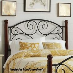 a bed with yellow and white comforters in a bedroom setting that has pictures on the wall above it