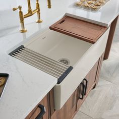 a kitchen with a sink, counter and gold faucet