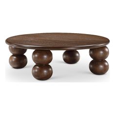 an oval wooden table with three balls on it's legs and one leg in the middle