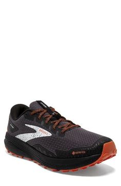 the brooks running shoe is available in black, orange and grey colors with white accents