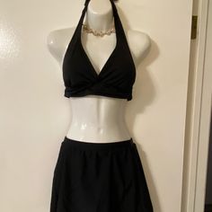 Black Halter Swim Top With Sewn In Pads By Catalina. Ties Around Neck And Back. Size M (8-10). Tried On But Never Worn In Water. Unbranded Black Swim Skirt - Never Worn. Elastic Waist Measures 12 1/2”. Full Coverage Lined Bottoms. Elegant Stretch Halter Top For Pool, Black Swim Dress With Built-in Bra For Beach Season, Black Swimwear With Built-in Bra For Spring, Elegant Halter Top For Poolside, Elegant Fitted Halter Top For Poolside, Black V-neck Lined Swimwear, Black Lined V-neck Swimwear, Black V-neck Summer Tankini, Black Tankini For Beach Season Party