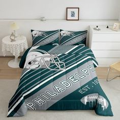 a bed room with a football comforter and pillows