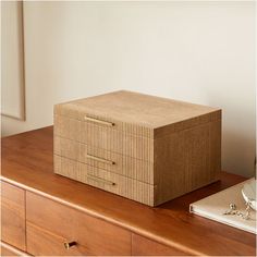 a box sitting on top of a wooden dresser