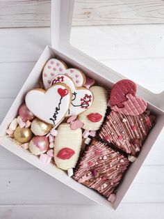 an open box filled with cookies and candy